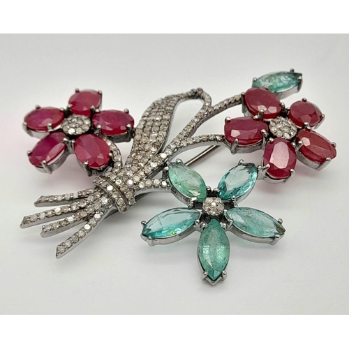 252 - An Emerald, Ruby and Diamond Floral Brooch - with gemstone weight 14.82ct , diamond weight 1.55cts. ... 