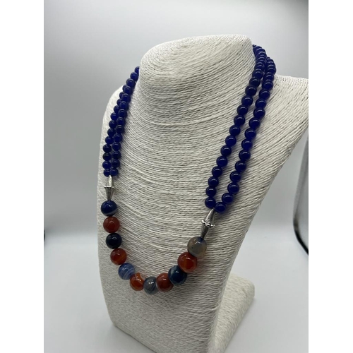 728 - A Stylish Multi-Coloured Onyx Bead Necklace. A row of double strand blue onyx beads connect to a sin... 