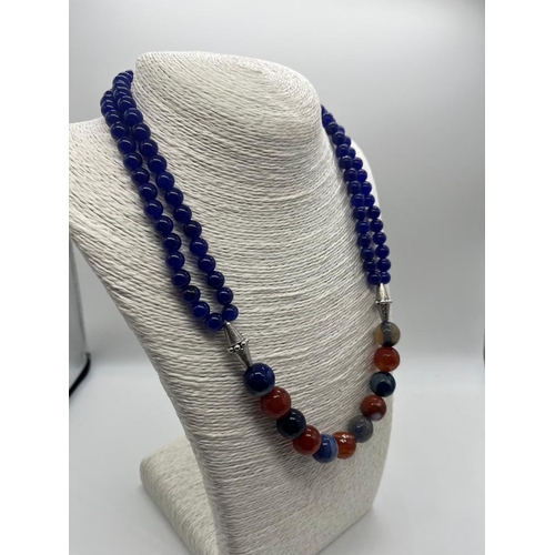 728 - A Stylish Multi-Coloured Onyx Bead Necklace. A row of double strand blue onyx beads connect to a sin... 