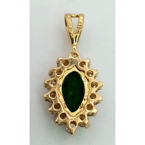 166 - An 18K Emerald and Diamond Pendant. Oval emerald with a diamond surround. 20mm. 1.3g total weight.