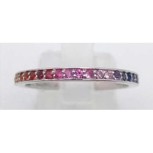 233 - A stunning Theo Fannell half eternity ring set with a rainbow of colour of natural sapphire. All unh... 