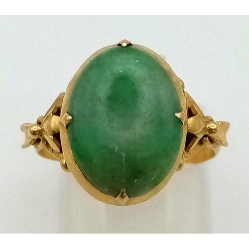 460 - An Art Nouveau 9K Gold (possibly higher) Jade Ring. A high-quality oval jade cabochon in a scrolled ... 