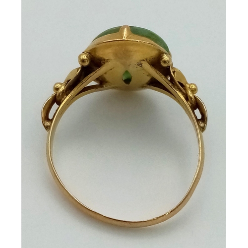 460 - An Art Nouveau 9K Gold (possibly higher) Jade Ring. A high-quality oval jade cabochon in a scrolled ... 