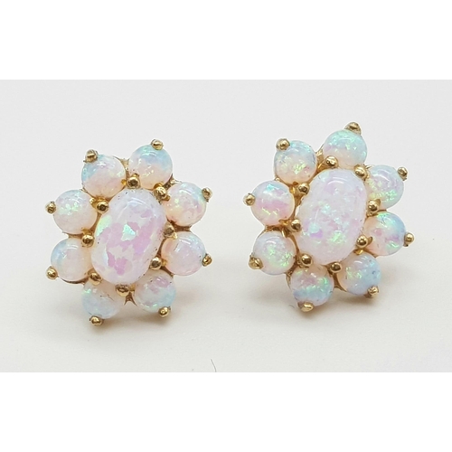 636 - A PAIR OF 9K GOLD OPAL EARRINGS IN A FLORAL SHAPE