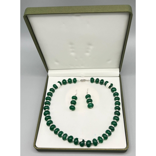 197 - A very elegant and sophisticated necklace and earrings set with large emerald cabochons and cubic zi... 