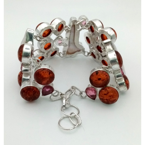 211 - A very unusual silver bracelet with a combination of numerous amber cabochons and large Biwa natural... 