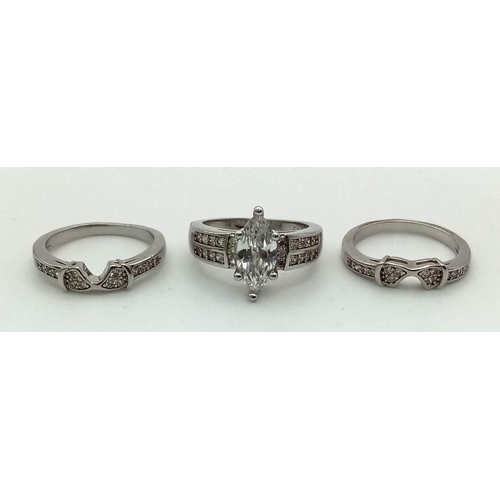 232 - A brilliant trilogy of sterling silver rings with cubic zirconia, presented in a vintage, blue and w... 