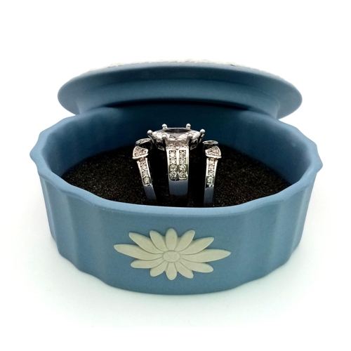 232 - A brilliant trilogy of sterling silver rings with cubic zirconia, presented in a vintage, blue and w... 