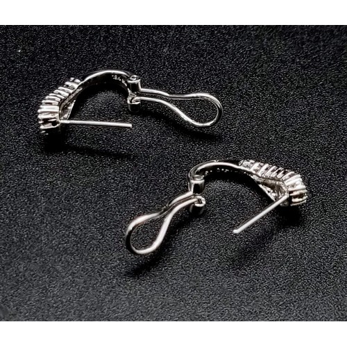 185 - An 18 K white gold pair of earrings with baguette and round cut diamonds (0.31 carats). Weight: 3.2 ... 