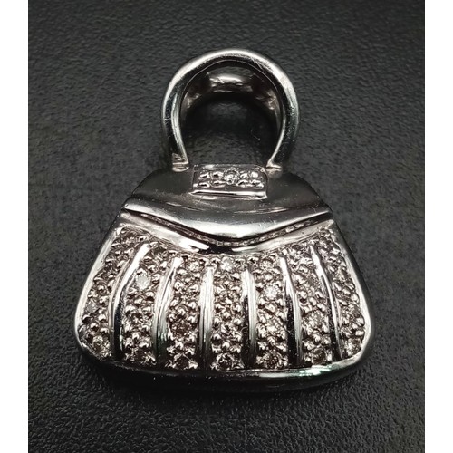 580 - A 9 K white gold, diamond set, hand bag charm/pendant. Weight: 2.5 g.