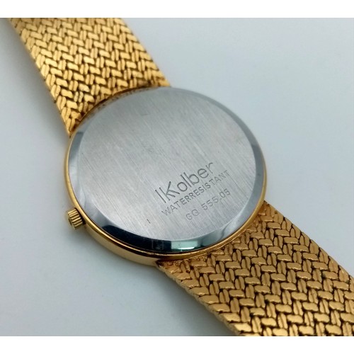 906 - A Kolber Geneve Gold Plated Quartz Gents Watch. Gold plated strap and case - 32mm. White dial with d... 