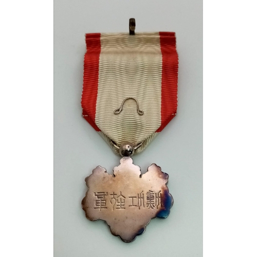 154 - A Japanese Order of The Rising Sun 7th Class Medal with Ribbon. Comes In original presentation case.