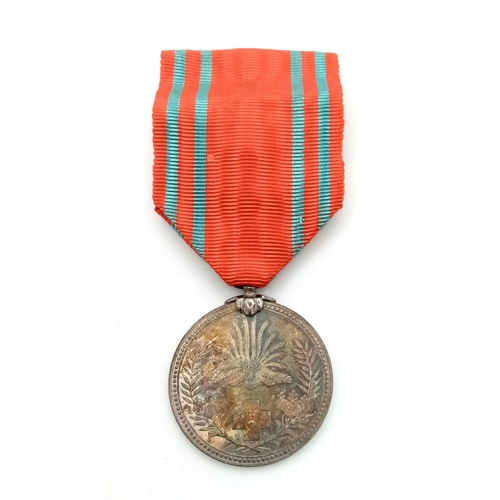 883 - A WW2 Japanese Red Cross Medal with Ribbon.