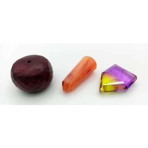 968 - A Mixed Lot of Gems. A Huge Ruby drilled bead. (71gms, 1 x 1 inches). An Iolite Pyramid (44gms, 1.10... 