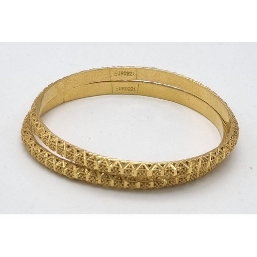 319 - A 22k Yellow Gold Lot Including: Two Asian wedding bangles (6cm inner diameter) and an Asian wedding... 