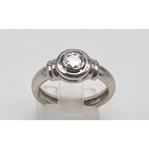 1287 - An 18K White Gold Diamond Solitaire Ring. Round cut diamond - 0,60ct. J-SI Grade. Size O. 5.5g.