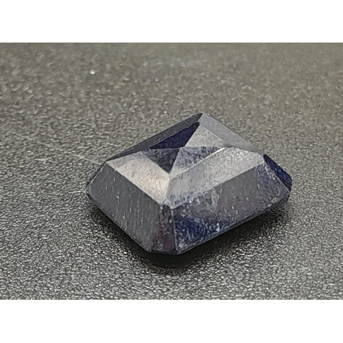 1383 - A 6.95ct Blue Sapphire - Rectangular shape. Comes with a certificate.