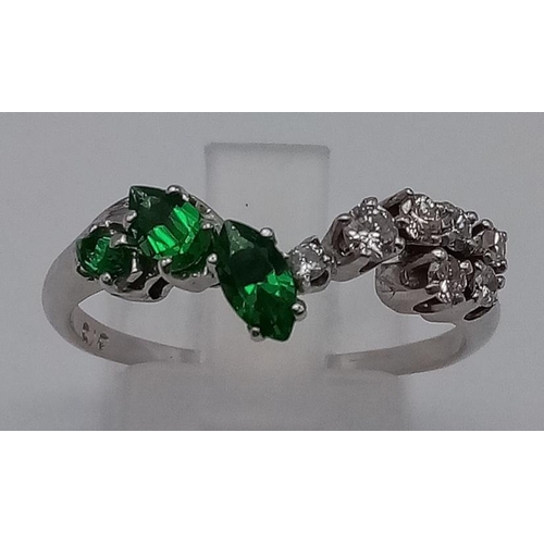 379 - A 9K White Gold Chevron Emerald and Diamond Ring. 3 Emeralds and 7 Diamonds. Size R. Total weight: 2... 