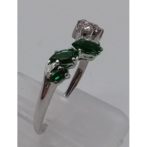 379 - A 9K White Gold Chevron Emerald and Diamond Ring. 3 Emeralds and 7 Diamonds. Size R. Total weight: 2... 