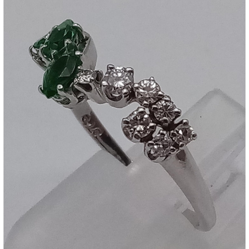 379 - A 9K White Gold Chevron Emerald and Diamond Ring. 3 Emeralds and 7 Diamonds. Size R. Total weight: 2... 