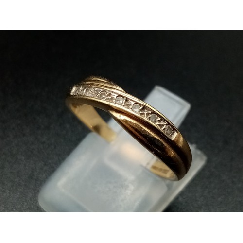 946 - A 9K Yellow Gold Crossover Diamond Band Ring. With a row of 7 diamonds. Size N. 
Total weight: 1.75g