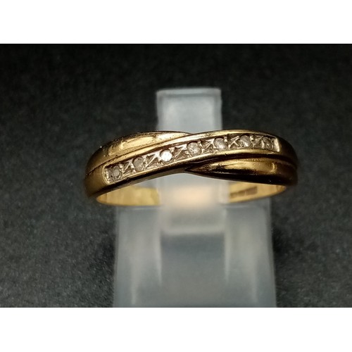 946 - A 9K Yellow Gold Crossover Diamond Band Ring. With a row of 7 diamonds. Size N. 
Total weight: 1.75g