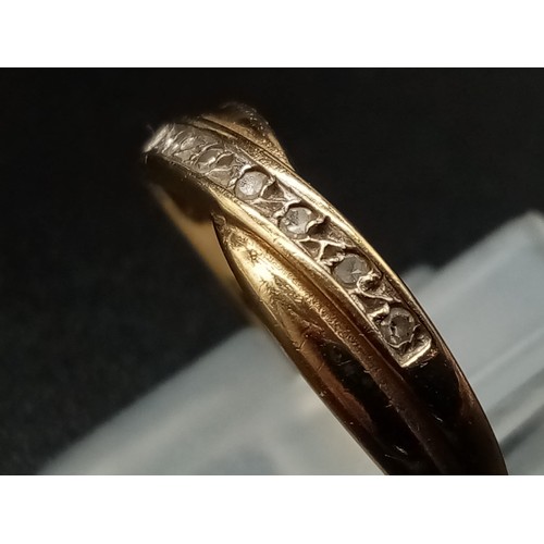 946 - A 9K Yellow Gold Crossover Diamond Band Ring. With a row of 7 diamonds. Size N. 
Total weight: 1.75g