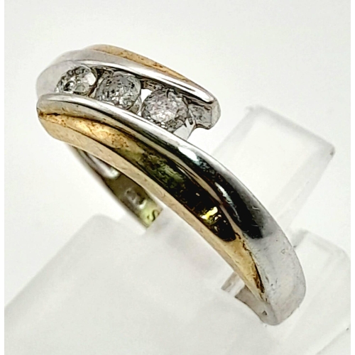 876 - A 9K White and Yellow Gold Crossover Ring with separated 3 Diamonds. Size N. Total weight: 2.50g