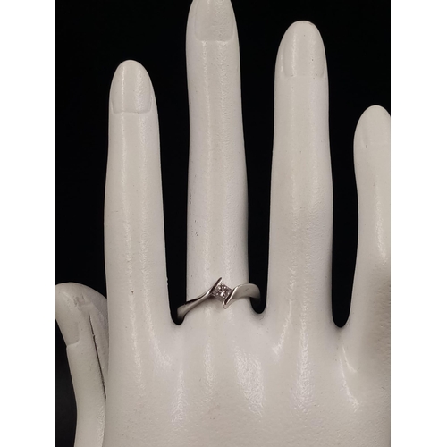 806 - An 18K White Gold Diamond Solitaire Ring. Keeper-esque design. Size M. 2.43g