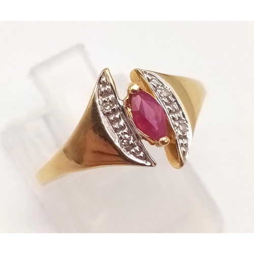 1073 - An 18K Yellow Gold Ruby and Diamond Ring. Marquise shaped centre ruby with diamond wings. Size N.
2g... 