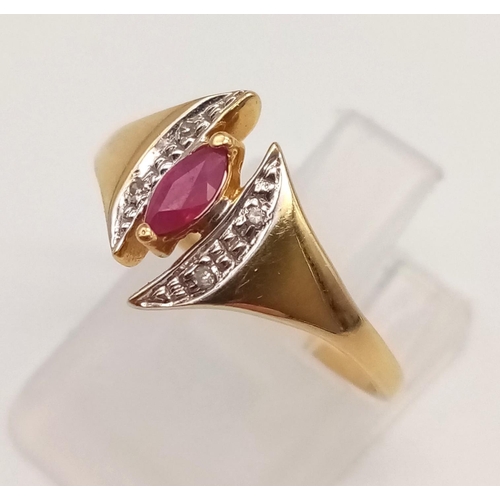 1073 - An 18K Yellow Gold Ruby and Diamond Ring. Marquise shaped centre ruby with diamond wings. Size N.
2g... 