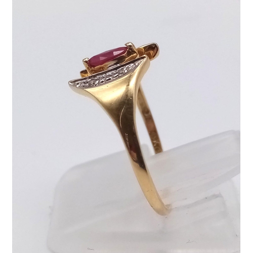 1073 - An 18K Yellow Gold Ruby and Diamond Ring. Marquise shaped centre ruby with diamond wings. Size N.
2g... 