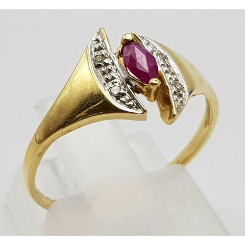 1073 - An 18K Yellow Gold Ruby and Diamond Ring. Marquise shaped centre ruby with diamond wings. Size N.
2g... 