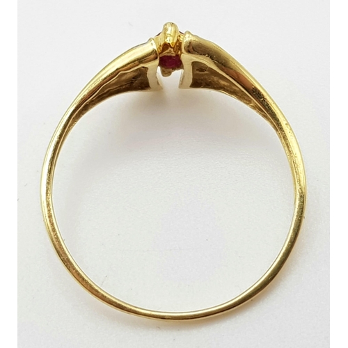 1073 - An 18K Yellow Gold Ruby and Diamond Ring. Marquise shaped centre ruby with diamond wings. Size N.
2g... 