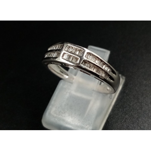 1024 - An 18K White Gold Two-Row Diamond Half-Eternity Ring. Size O. 3.44g