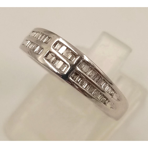 1024 - An 18K White Gold Two-Row Diamond Half-Eternity Ring. Size O. 3.44g