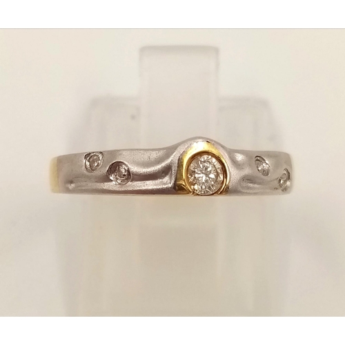 834 - An 18K Yellow and White Gold Diamond Ring. Size L1/2.
2.23g