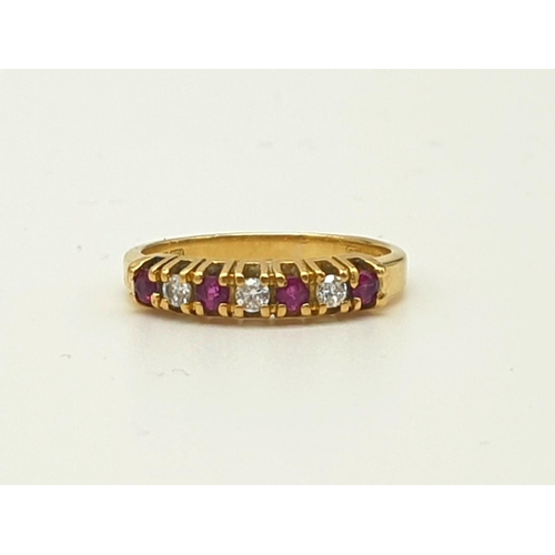 974 - An 18K Yellow Gold Ruby and Diamond Ring. Seven stones. Size I. 2.27g