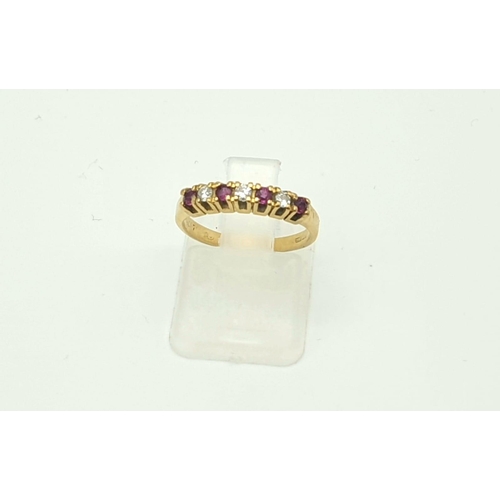 974 - An 18K Yellow Gold Ruby and Diamond Ring. Seven stones. Size I. 2.27g