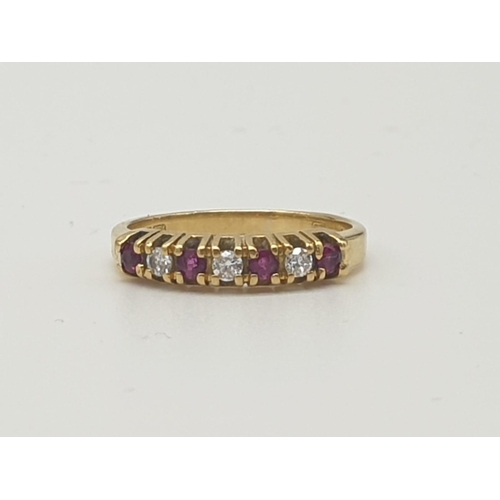 974 - An 18K Yellow Gold Ruby and Diamond Ring. Seven stones. Size I. 2.27g