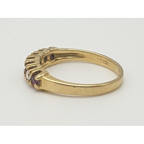 974 - An 18K Yellow Gold Ruby and Diamond Ring. Seven stones. Size I. 2.27g