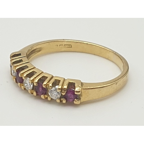 974 - An 18K Yellow Gold Ruby and Diamond Ring. Seven stones. Size I. 2.27g