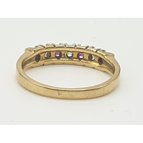 974 - An 18K Yellow Gold Ruby and Diamond Ring. Seven stones. Size I. 2.27g