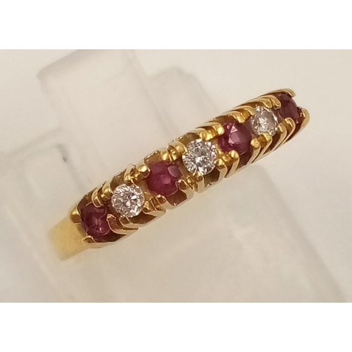 974 - An 18K Yellow Gold Ruby and Diamond Ring. Seven stones. Size I. 2.27g