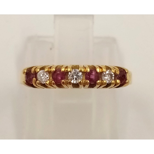 974 - An 18K Yellow Gold Ruby and Diamond Ring. Seven stones. Size I. 2.27g