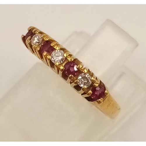 974 - An 18K Yellow Gold Ruby and Diamond Ring. Seven stones. Size I. 2.27g