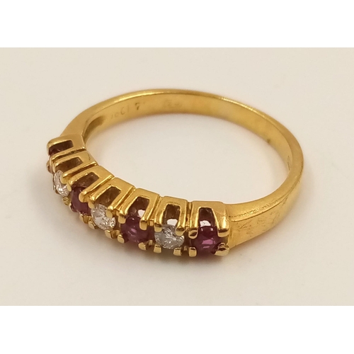 974 - An 18K Yellow Gold Ruby and Diamond Ring. Seven stones. Size I. 2.27g