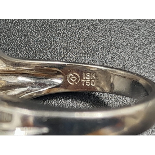 372 - A Modern 18K White Gold Twist Diamond Ring. Size M.
8.79g.