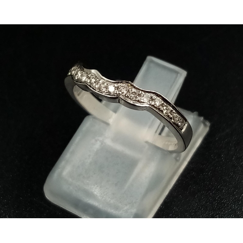 1010 - An 18k White Gold Diamond Half-Eternity Ring. Size L.
2.5g.