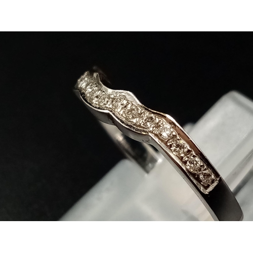 1010 - An 18k White Gold Diamond Half-Eternity Ring. Size L.
2.5g.